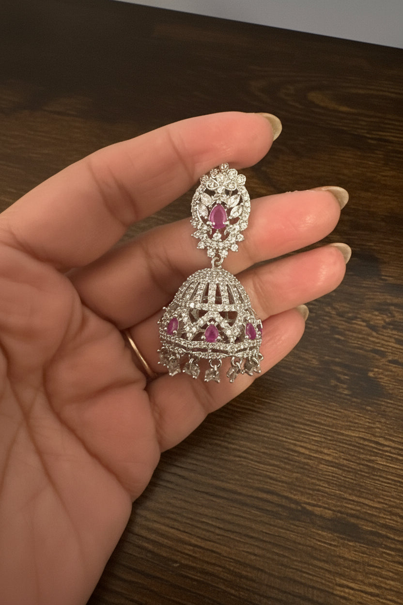 Silver AD Jhumka Earrings with Ruby Stones – CZ Pavé Dome Jhumki with Ruby Accent & Crystal Drops Nikhar Jewelry