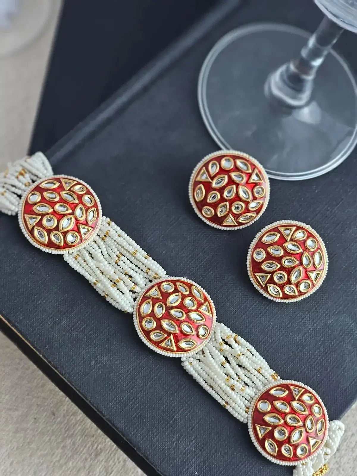 red Kundan choker set features the classic Kundan technique where gemstones are set in gold foil Close up look