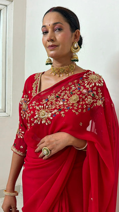 Red Saree with heavy hand work of seqyism, pearls, cutdana work and green stonework Maha Collection
