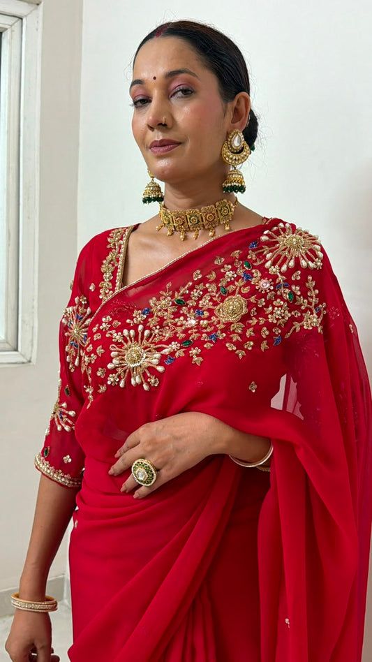 Red Saree with heavy hand work of seqyism, pearls, cutdana work and green stonework Maha Collection