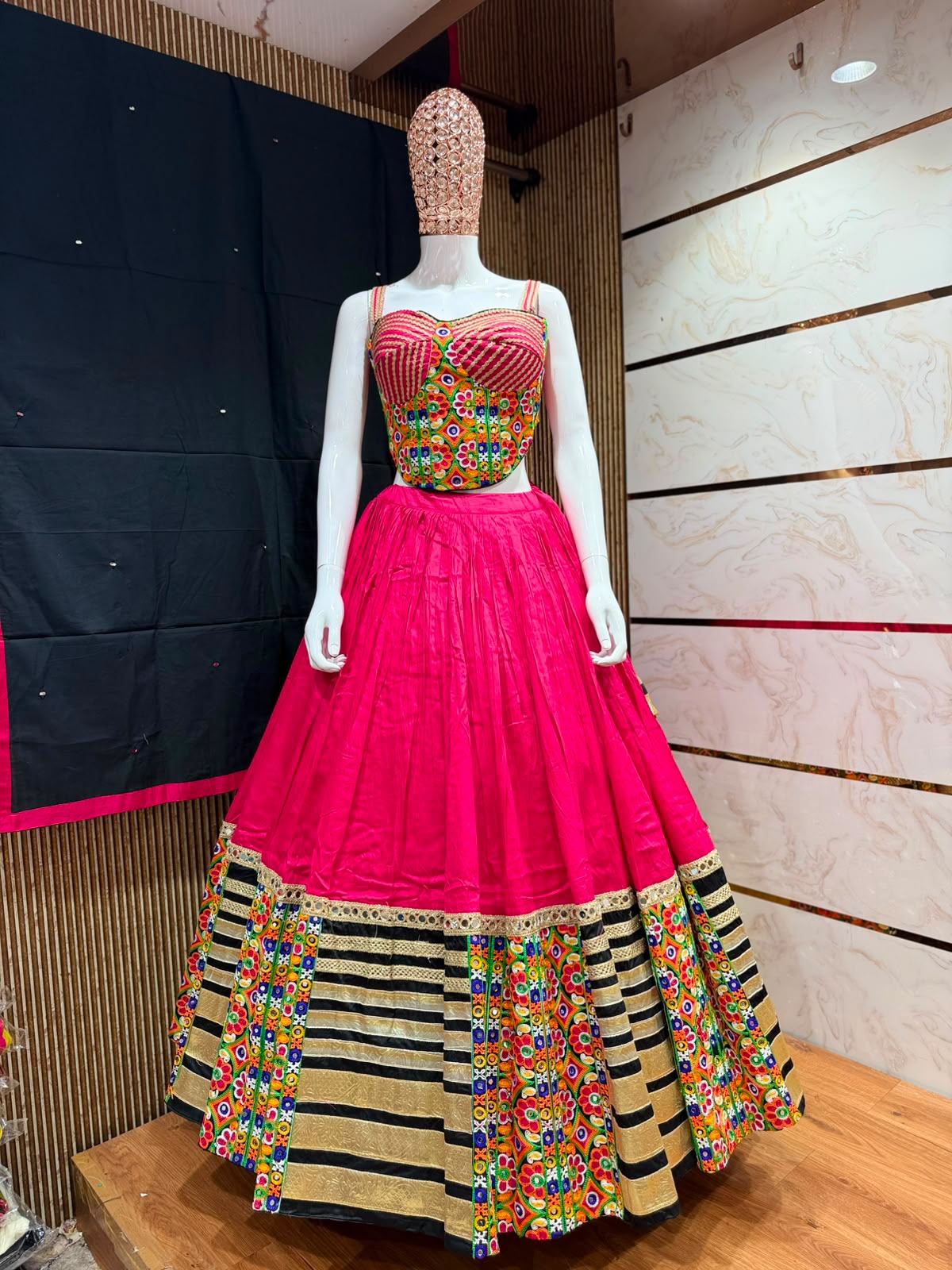 Flat lay of rani pink Nazakat Chaniya Choli set showing full 8-metre flare, Kutchi corset blouse and dupatta