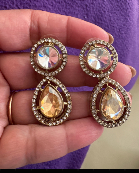 Champagne crystal drop earrings front view showing round iridescent AB crystal top with CZ pavé halo and large pear-cut champagne teardrop bottom with CZ pavé halo